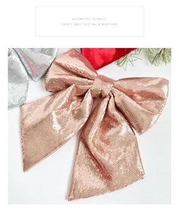 Macro shot of sparkling rose gold Christmas bow with glitter sequins and festive decor