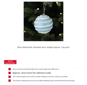Close-up of 8cm blue Christmas ball with white glitter and pearl lines on tree