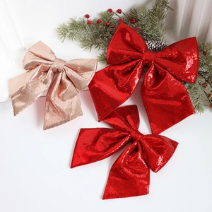 Sparkling Christmas glitter bows in red and champagne gold for festive tree decoration