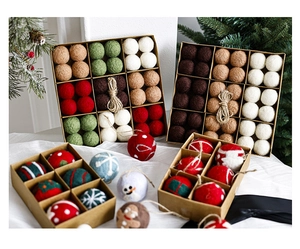 Close-up of wool felt Christmas balls with festive patterns in a kraft paper gift box