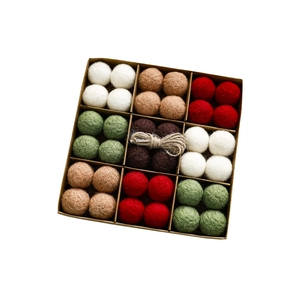 Christmas wool felt ball ornament set with colorful spheres and twine in a kraft gift box