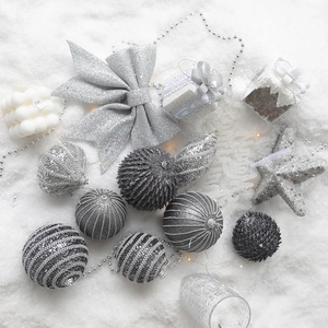 Silver Christmas tree ornaments set including glitter bows, stars and balls on white snow