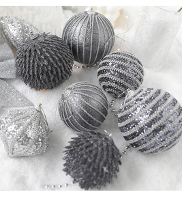 Macro shot of silver and grey Christmas balls with glitter and striped textures