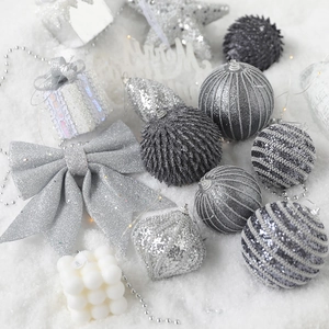 Silver Christmas ornaments set with glitter stars, striped baubles and festive bows