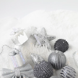 Silver Christmas tree ornaments set with glitter stars and balls on white snow surface