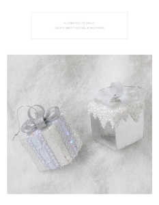 Detail of silver Christmas gift box ornaments with glitter and snow textures on white fur