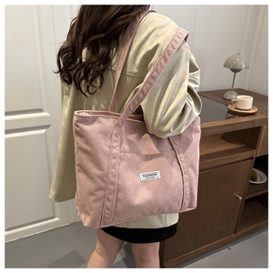 Pink corduroy tote bag detail with Fashion Instinct label and spacious front pocket