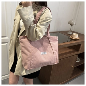 Pink corduroy tote bag showing the soft ribbed texture and Fashion Instinct label detail