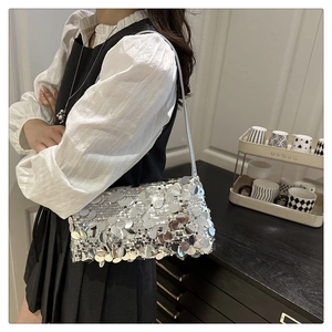 Detailed view of silver sequin shoulder bag showing reflective metallic disc texture