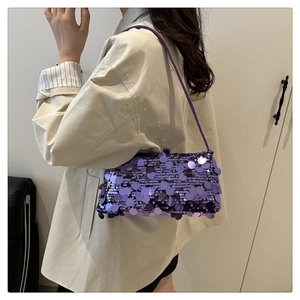 Detail of purple sequined shoulder bag showing metallic glitter texture on the surface