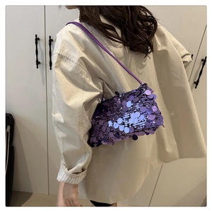 Close-up of purple sequin shoulder bag on model showing texture and fashion style