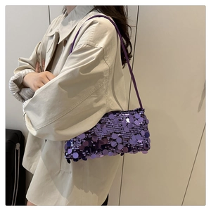 Detail view of purple sequin shoulder bag showing metallic circular glitter texture