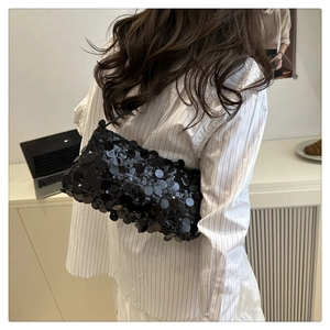 Detail of a black sequined shoulder bag showing reflective texture and chic evening style
