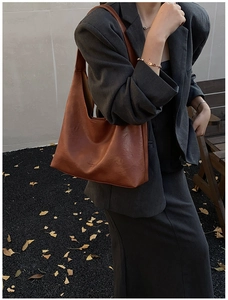 Close-up of caramel brown leather tote bag showing fine texture and fashion embossing