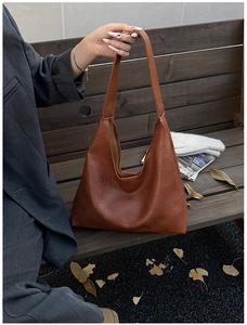 Close-up of the vintage brown hobo bag showing the high-quality leather texture and logo