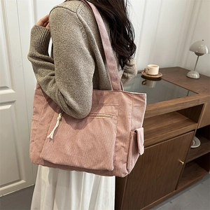 Sac fourre-tout rose en velours côtelé avec poche latérale et gland zippé