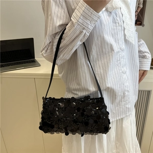 Fashionable black sequin underarm bag with shimmering texture and slim shoulder strap