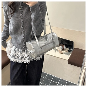 Mirror selfie showing a silver Boston shoulder bag with metallic finish and adjustable strap