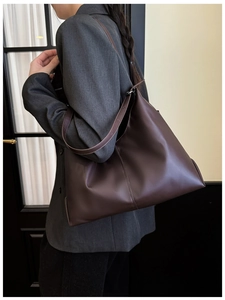 Side view of large coffee brown tote bag showing its spacious design for daily commuting