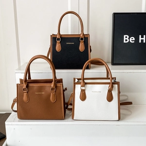 Three retro lychee pattern leather tote bags in black, brown, and white with top handles