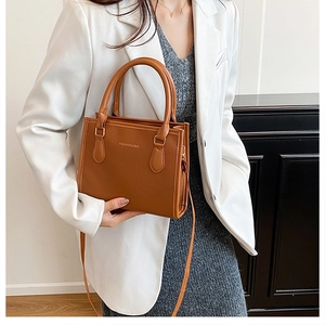 Brown textured leather shoulder bag with gold 'FASHION & BAG' lettering and handle