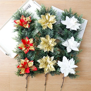Detailed view of artificial Christmas pine picks with glittered poinsettia flowers