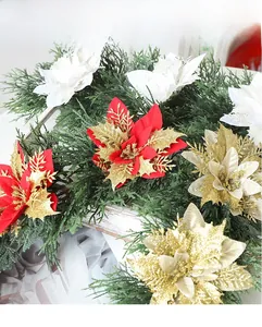 Close-up of artificial Christmas garland with red, white, and gold glitter flowers