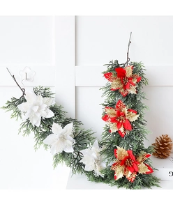 Detail of Christmas wreath with white and red poinsettias and golden glitter pine needles