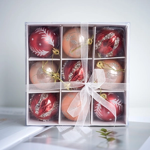 9-piece set of deep red and champagne Christmas tree ornaments with glitter designs