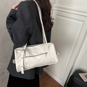White cylinder pillow shoulder bag with silver zipper and wide strap for casual daily use