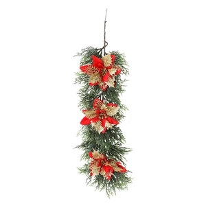 Christmas hanging garland with green pine needles, red poinsettia flowers and gold leaves