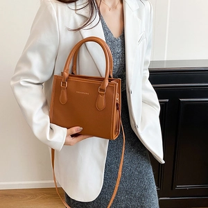 Brown lychee leather tote bag with top handle and shoulder strap for office commuting