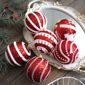 Macro detail of six pink glitter Christmas balls with white velvet trim on a vintage tray