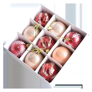 Set of 9 bronze and red Christmas baubles with glitter leaf patterns in a white gift box
