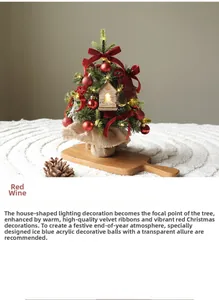 Mini desktop Christmas tree with LED lights, red bows, and burlap base on wood tray