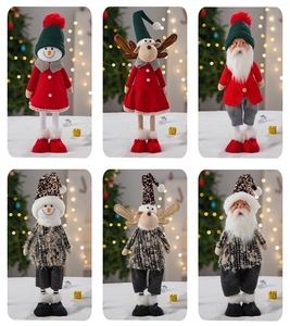 Detail of Christmas gnomes and reindeer dolls in red, green and black gold sequin outfits