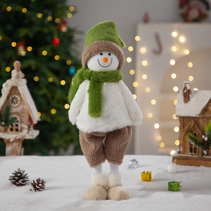 Handmade Christmas faceless gnome doll in green hat standing in a winter scene