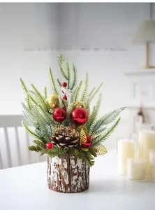 Mini Christmas tree arrangement with artificial pine, red balls and rustic log base