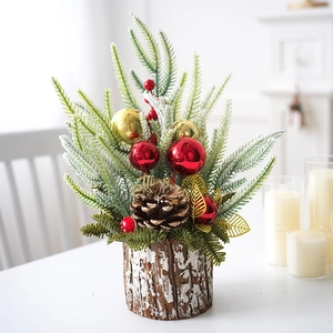Mini Christmas tree in wooden base with red berries, pine cones and snow-dusted leaves
