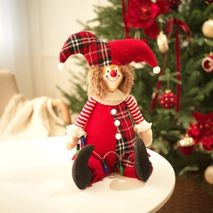 Close-up of a festive Christmas clown doll with red plaid hat near a decorated tree