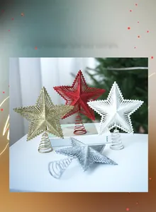 Detail of glittery star tree toppers in gold, red, and silver with spring base