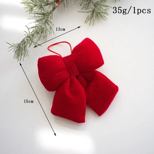 Detail of red velvet Christmas bow ornament with red string for festive tree decoration
