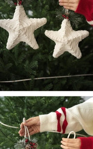 Detail of handmade star-shaped hemp rope Christmas ornament with red berries and pine needles