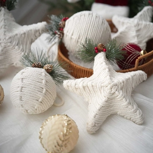 Handcrafted white cotton macrame Christmas ornaments with pine cones and berries decoration
