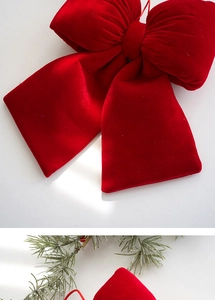 Close-up of a plush red velvet Christmas bow showing rich texture and festive details