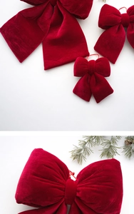 Macro shot of red velvet Christmas bows showing soft fabric texture and hanging string