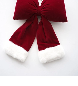 Detailed close-up of red velvet Christmas bow with soft white faux fur trim decor