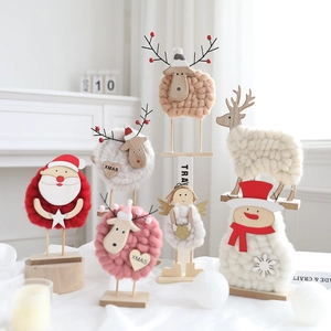 Handmade wool felt Christmas figurines with wooden bases including Santa and reindeer
