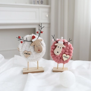 Detail of wool felt Christmas reindeer ornaments with wooden XMAS heart tags and hats