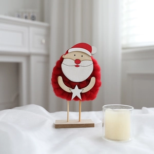 Detail of wool felt Santa Claus table ornament with red yarn and a wooden base stand